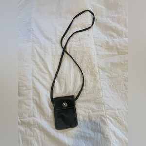ROOTS black leather mini crossbody with turn lock closure.